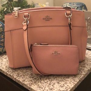 A beautiful pink coach purse and wallet set.
